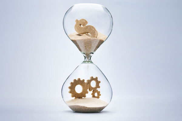 Hourglass with sand as dollar sign and gears.