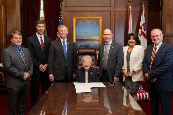 Attendees at the Alabama Dam Safety Act bill signing (l to r): Jeff Smitherman, Director, Alabama Emergency Management Agency; Chris Crawford, PE (TTL), President, ACEC/Alabama; Lawren Pratt, PE (Barge Design Solutions), ACEC/ASCE; Alabama Governor Kay Ivey; Senator Clyde Chambliss, PE (Chambliss Engineering), Alabama State Senate; Renee Anne Casillas, Executive Director & CEO, ACEC Alabama; and Steve Newton, PE (TTL), ACEC/ASCE.